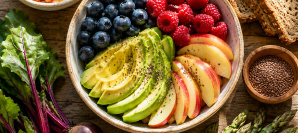 A colorful overhead flat-lay of fiber-rich superfoods for gut health, including avocados, berries, oats, and prebiotic vegetables.